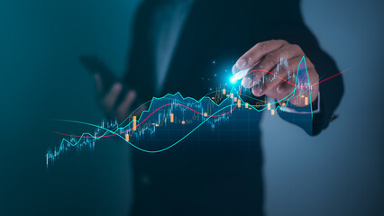 Businessman using pen touch candlestick chart financial growth of business and world economy, Stock...