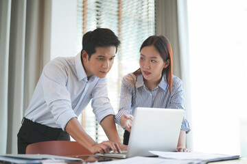 Asian office employee supervising Mentor training trainee at office