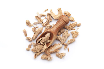 A wooden scoop filled with organic dry Ginger root (Zingiber officinale) or sonth, placed on a heap of ginger roots, isolated on a white background.