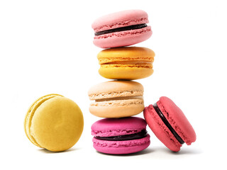 Pile of macaron cookies in various flavours and colours isolated on white background.