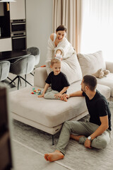 Happy family playing together in living room