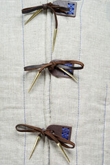 Detailed Close-Up of Decorative Fastenings on Fabric Surface