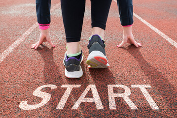 Women's legs on a treadmill at the stadium, running, beginning, start, planning, goal.