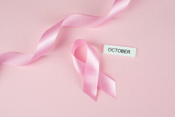Pink ribbon on pink background.