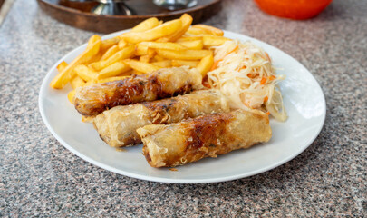 Fried spring rolls. Crispy springrolls, roasted egg rolls with French fries and Vietnamese sauces