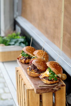 Gourmet Mini Burgers On Wooden Board