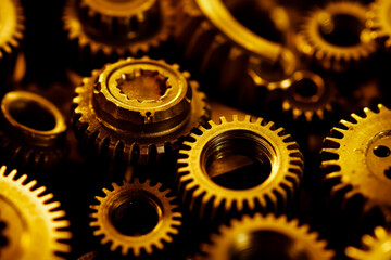 A bunch of gold gears that are laying on top of each other