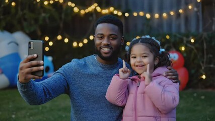 A heartwarming scene of a father taking a picture of his little girl, creating cherished memories on Fathers Day.