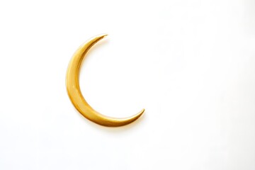 Obraz premium Golden Crescent Moon Glowing Softly Against a Light Background