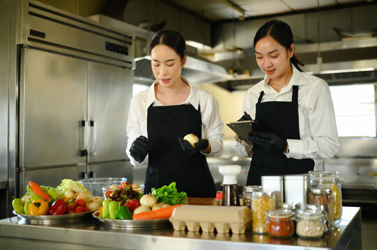 Female student learning food preparation techniques in cooking class