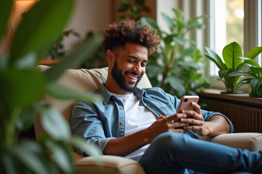 Handsome man relaxing on comfy armchair among home plants holding in hands smartphone. No stress, home owner, modern tech usage, fun concept. AI