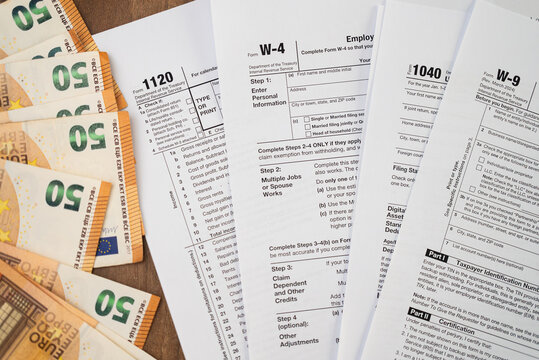 Tax forms and scattered euro bills highlight work involved in navigating tax responsibilities symbolizing annual financial review process in company operating legally