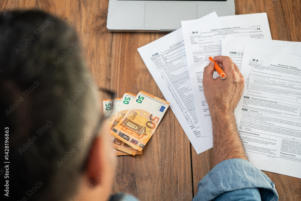 Aufkleber man accountant examines different types of tax forms for businesses to avoid penalties from governme