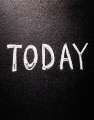 Fototapeta premium Chalk writing on blackboard with the word 'today' in bold letters