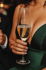 Beautiful woman enjoying a drink from a glass indoors with a happy expression