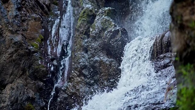 Top-down close-up of fresh mountain water cascading off a rocky cliff in Karnataka's Western Ghats