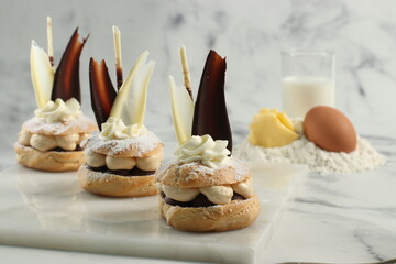 saint honore choux with creamy filling  and creamy garnish and chocolate 