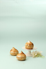 three meringue lemon choux, one in a cake stand