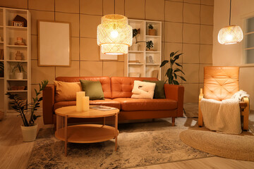 Interior of stylish living room with brown sofa, coffee table and glowing lamps at evening
