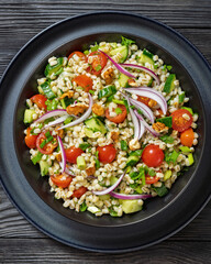 Barley salad with vegetables and walnuts in a bowl