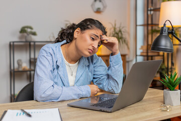 Angry furious woman freelancer using laptop while working at home office having nervous breakdown...