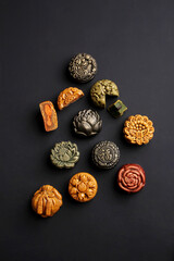 assorted mooncakes on a dark background
