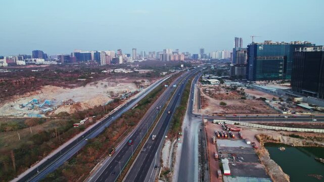 outer ring road with Service Road and commercial buildings at day time, rising shot, drone shot, 4k.
