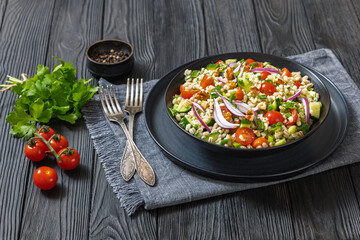 Barley salad with vegetables and walnuts in a bowl