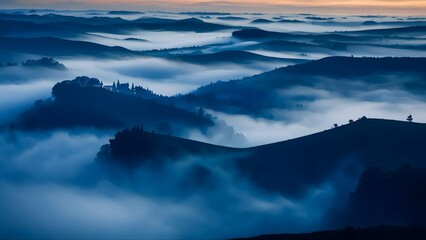 Fototapeta premium The sky is covered in a thick layer of fog, creating a serene and peaceful atmosphere. The misty landscape is dotted with trees and hills, giving the impression of a tranquil and isolated setting