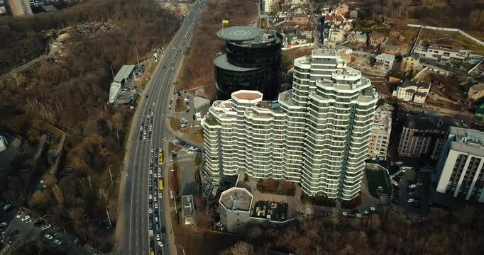 Aerial view of PecherSKY apartments and IQ Business Center with helipad in Kyiv, Ukraine, showcasing upscale living and corporate skyline.