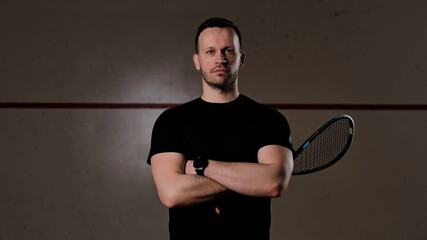 Dark-lit court enhances focus on coach’s stance, presence, and athletic attitude