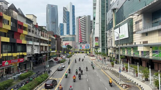 Downtown busy traffic cars and motorbikes in kl kuala lumpur city malaysia