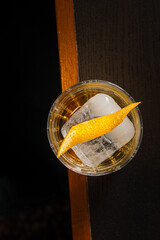 Golden Whiskey Cocktail Ice Cube Citrus Twist Dark Mood