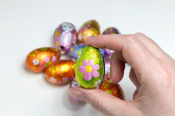Female hand holding chocolate Easter egg