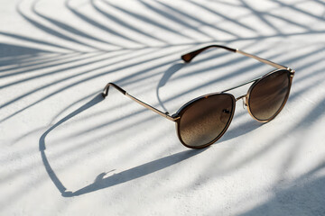 Stylish Round Sunglasses with Gradient Lenses on White Surface	