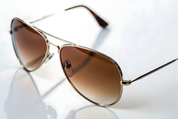 Stylish Round Sunglasses with Gradient Lenses on White Surface	