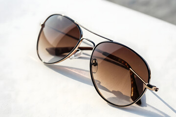 Stylish Round Sunglasses with Gradient Lenses on White Surface	