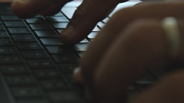 Programmer writing code on a laptop keyboard montage