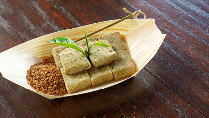 Mochi warabi mochi on a wooden table.