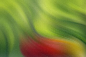 Still life of fresh produce featuring a red bell pepper tomato orange and green apple outdoors on a table