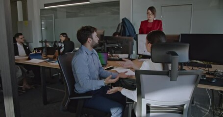 Diverse business team working together in a modern office. Collaboration and communication in a professional environment.