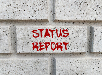 Status report message written on gray stone wall. Conceptual status report symbol. Copy space.