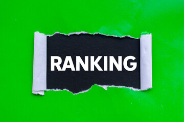Ranking message written on ripped torn green paper on black background. Conceptual ranking symbol....