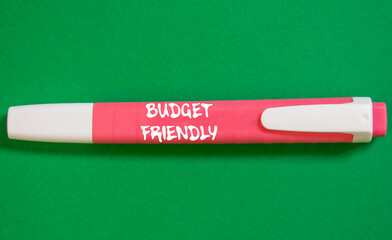 Budget friendly message written on pink marker pen on green background. Conceptual budget friendly...