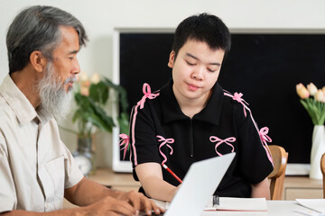 Guided Learning and Family Support. A girl with Down syndrome receives guidance from a family...