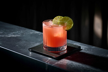 Rum punch cocktail with lime garnish