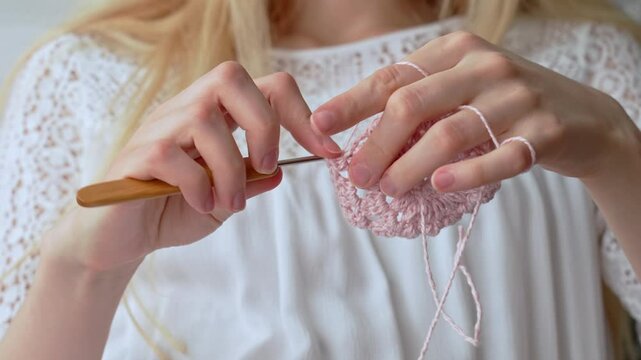 Girl Crocheting Elegant Lace by Hand. Women's hands crocheting an openwork product. 
