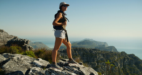 Hiking, mountain and thinking with woman in nature for fitness, travel adventure and workout. Space, reflection and exercise with person outdoor view on cliff for trekking holiday, explore and peace