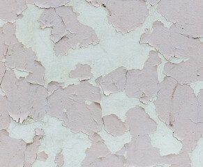 The wall is covered in peeling paint, giving it a worn and aged appearance