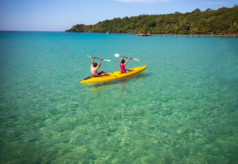 Asian senior couple on kayak in adventure travel in south east asia.